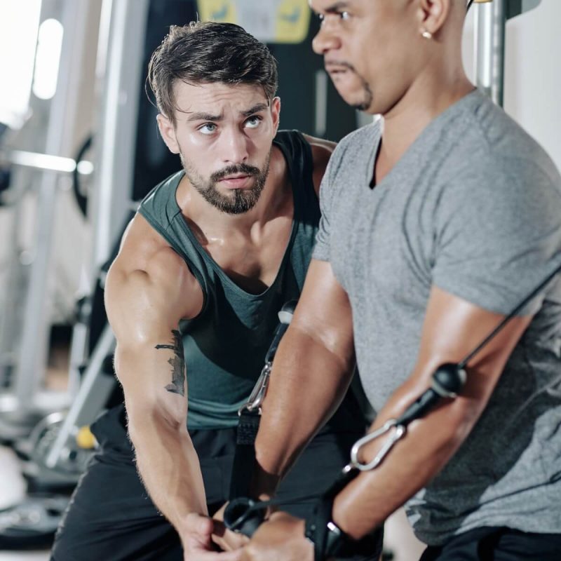 fitness-trainer-controlling-exercising-man.jpg