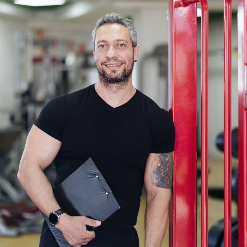 personal-fitness-trainer-with-workout-plan-close-up-on-gym-background.jpg