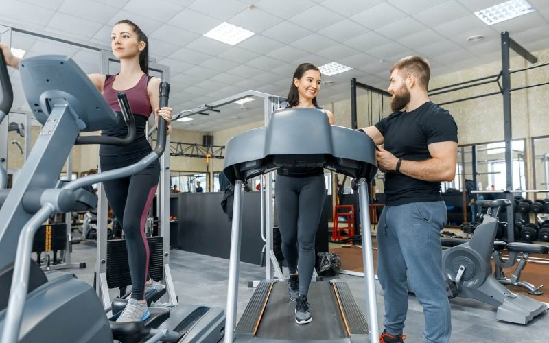 young-smiling-fitness-women-with-personal-trainer.jpg