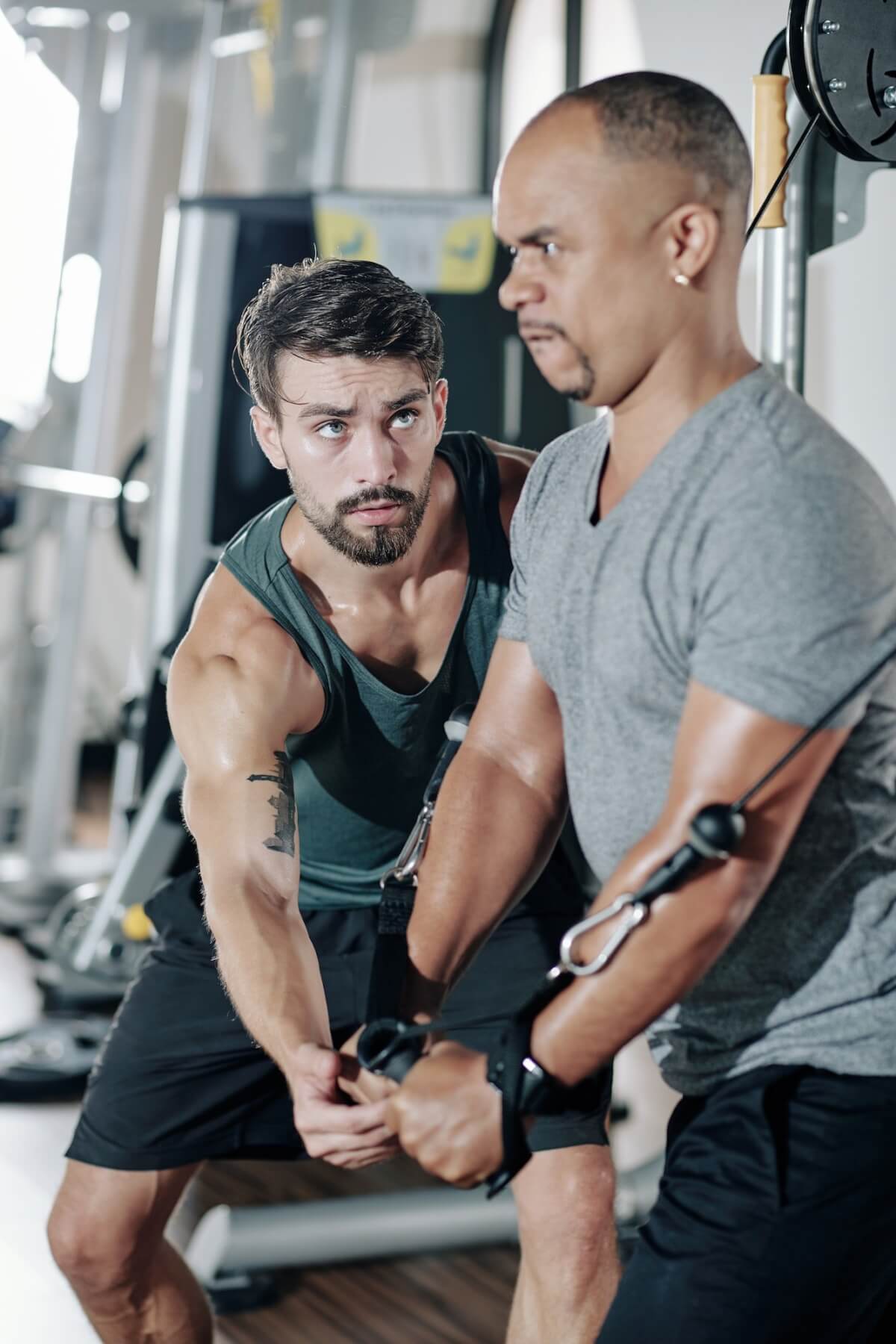 fitness-trainer-controlling-exercising-man.jpg