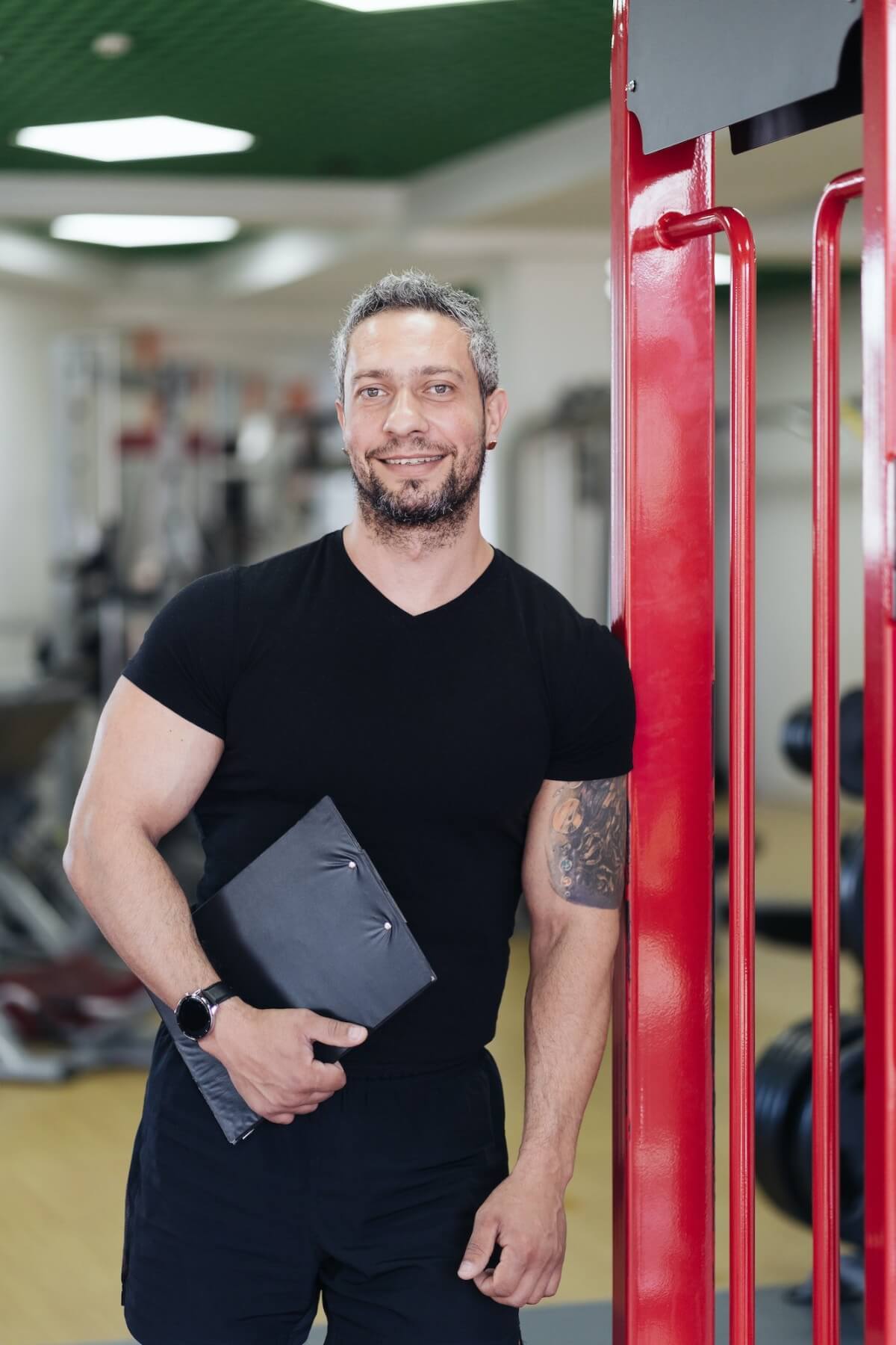 personal-fitness-trainer-with-workout-plan-close-up-on-gym-background.jpg