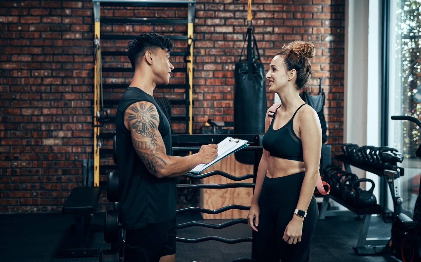 shot-of-a-sporty-young-woman-talking-to-a-fitness-trainer-at-the-gym.jpg