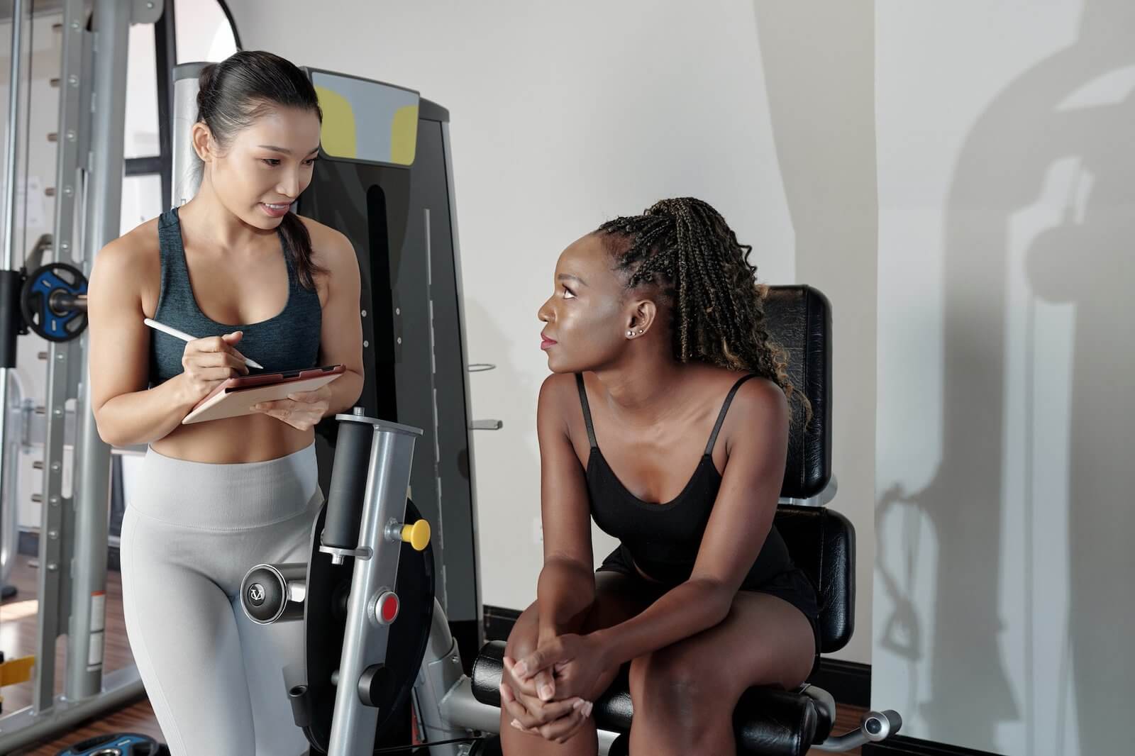 woman-listening-to-recommendations-of-fitness-trainer.jpg